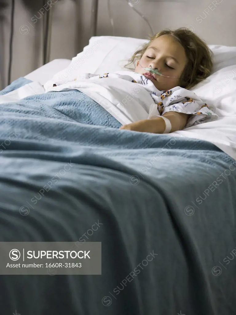 Young girl in hospital bed with respirator