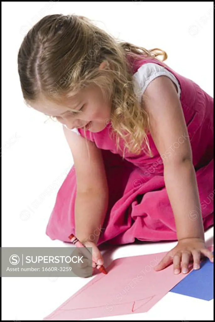 Close-up of a girl drawing on a sheet of paper