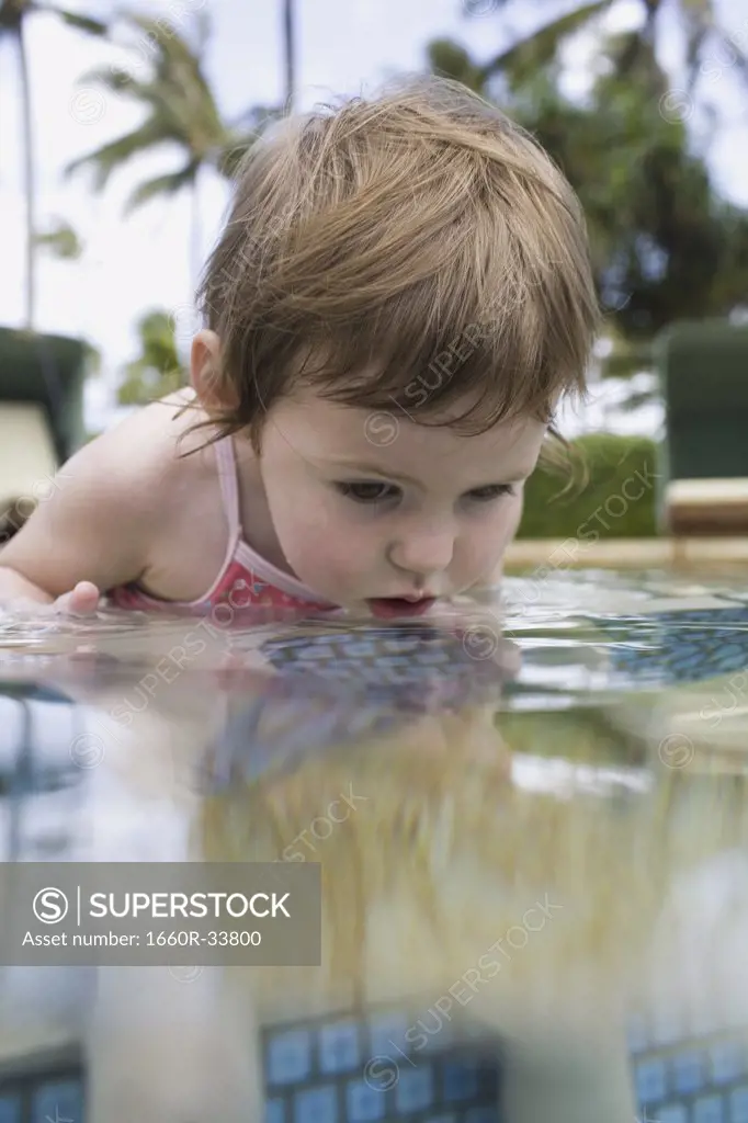 Girl sitting in outdoor pool