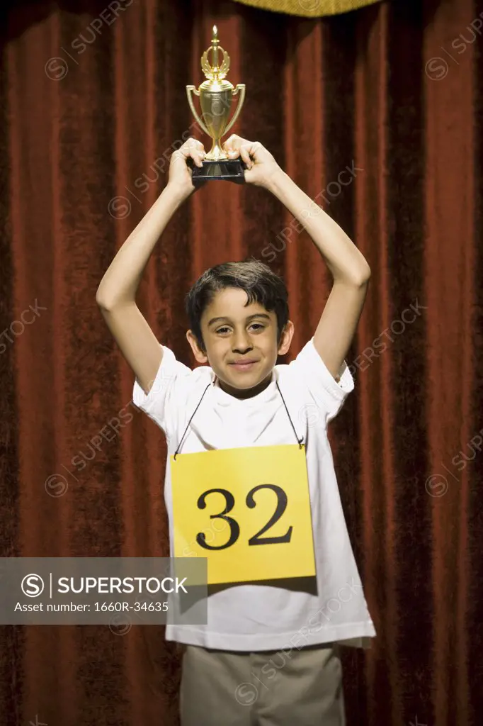 Boy contestant holding trophy