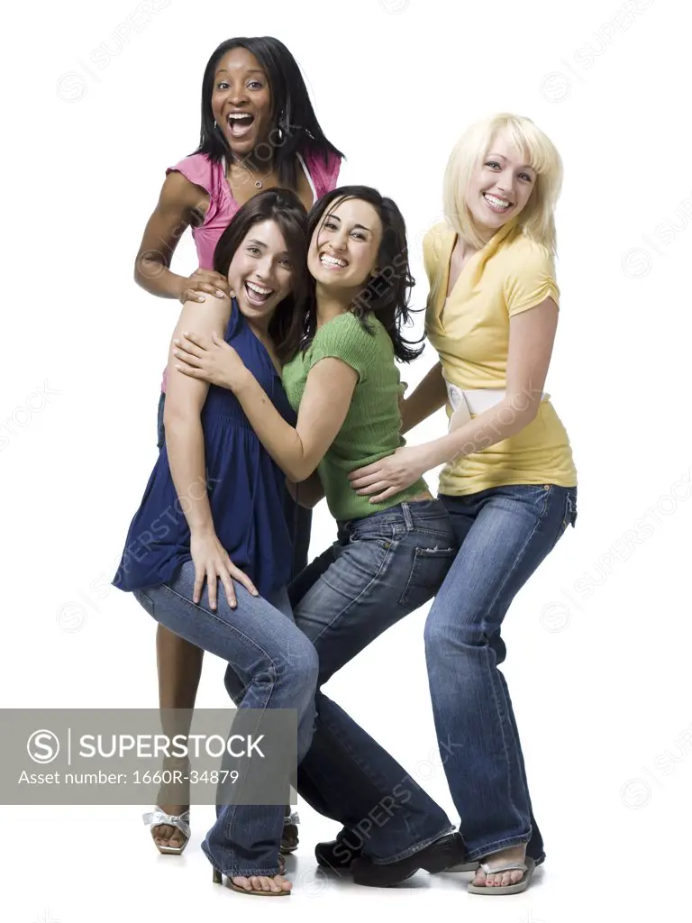 Four women hugging and smiling