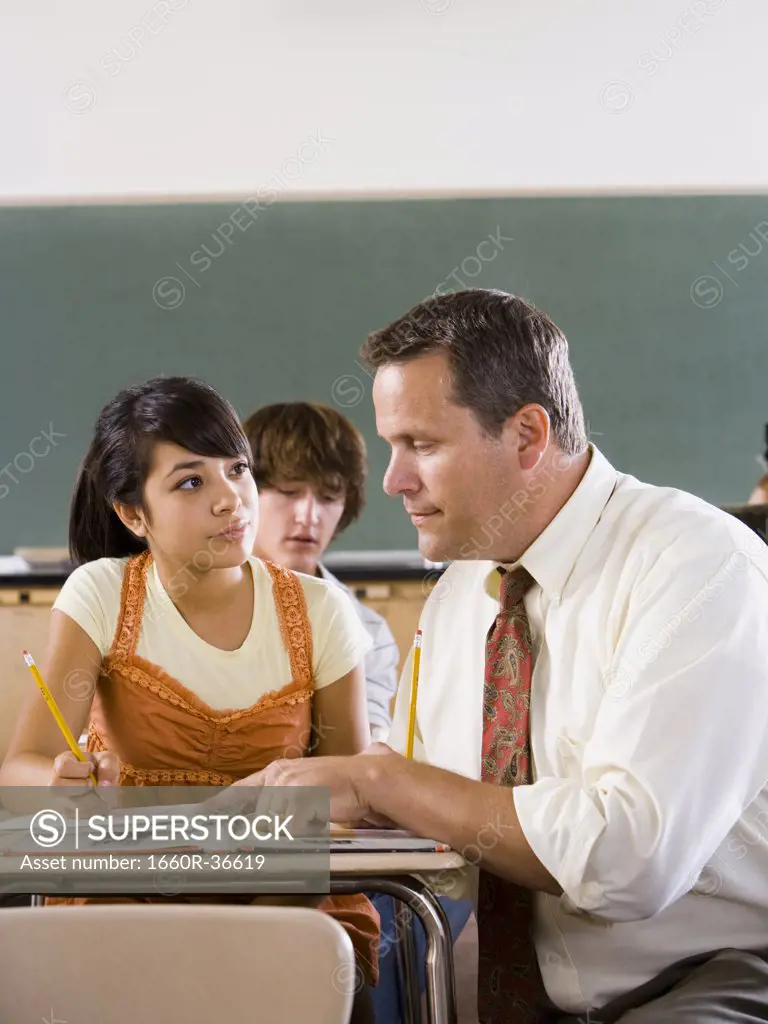 Student and teacher in a classroom.