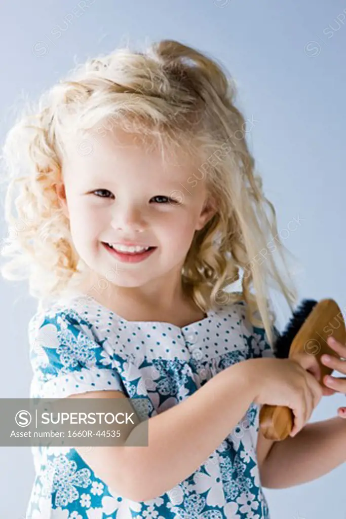 little girl brushing her hair