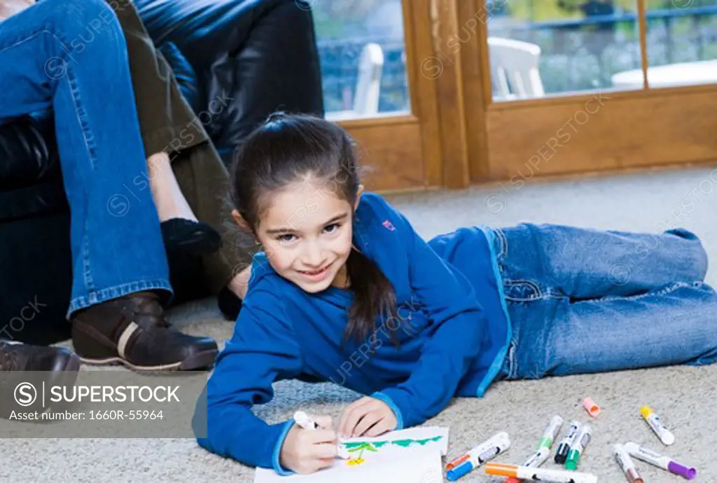 Young girl coloring with markers