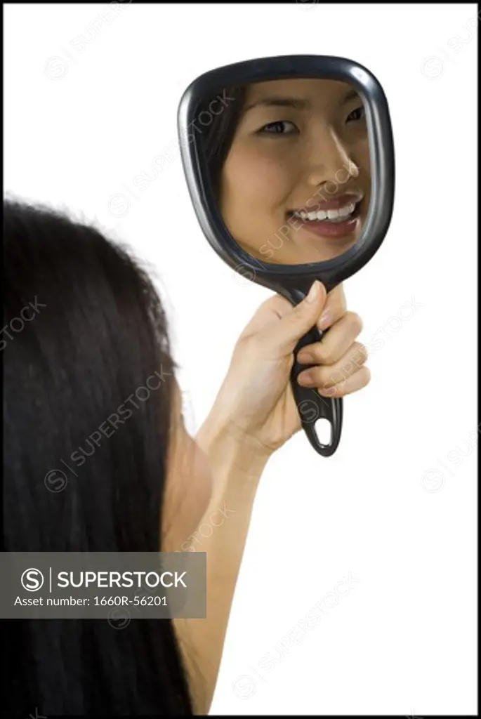 Reflection of woman in hand mirror