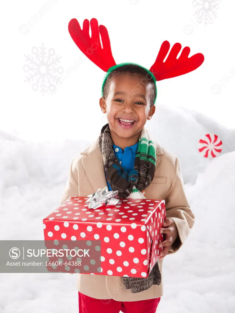 Boy holding a christmas gift.