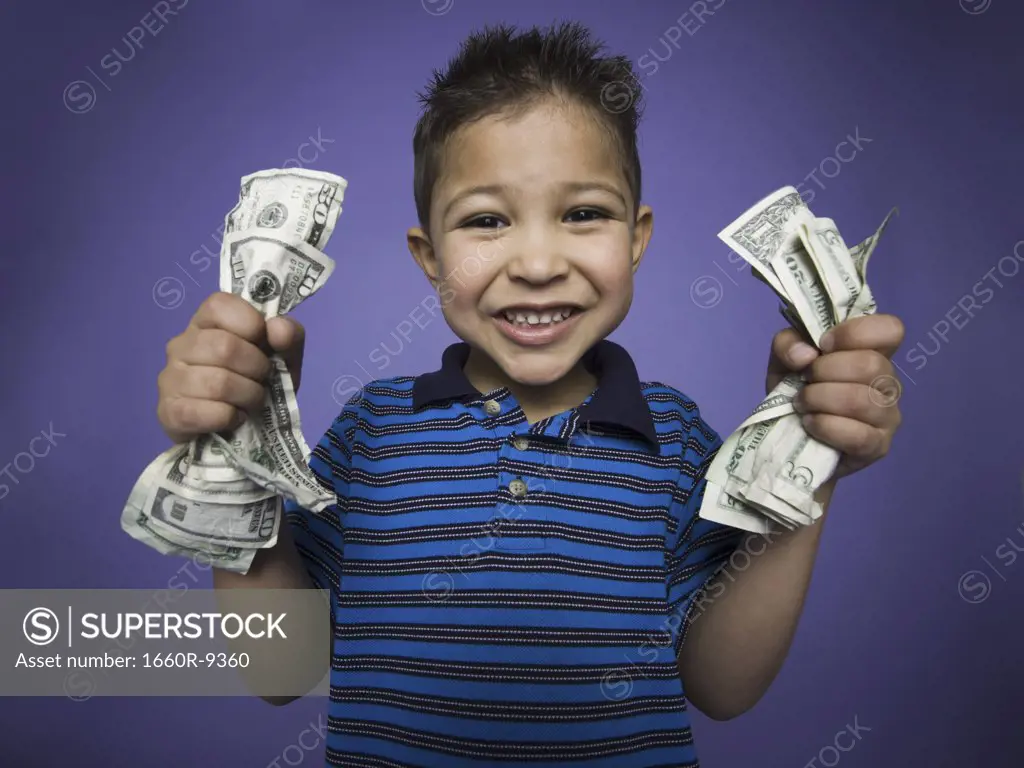 Portrait of a boy holding dollar bills