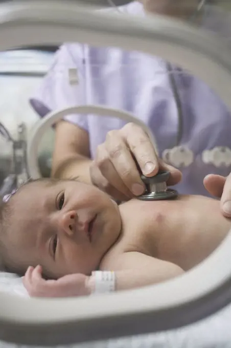 Doctor examining a newborn baby boy