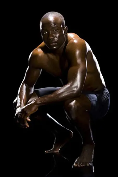 Muscular athlete in dark room