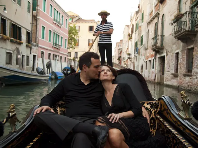 Italy, Venice, Mature couple embracing in gondola