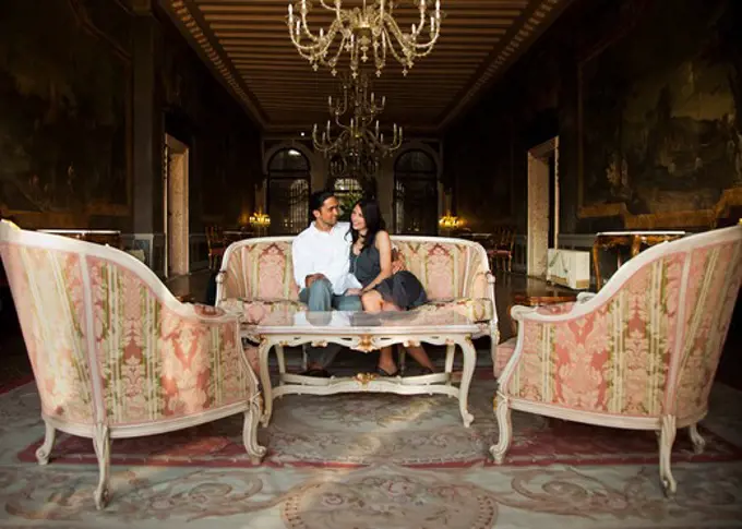 Italy, Venice, Young couple sitting in elegant lounge