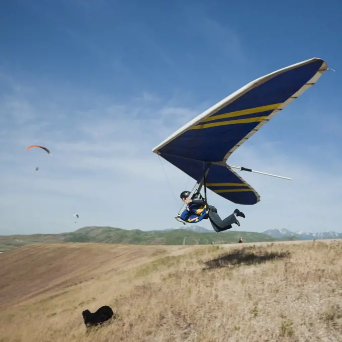 USA, Utah, Lehi, young man taking off with hang glider