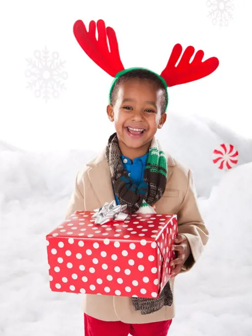 Boy holding a christmas gift.