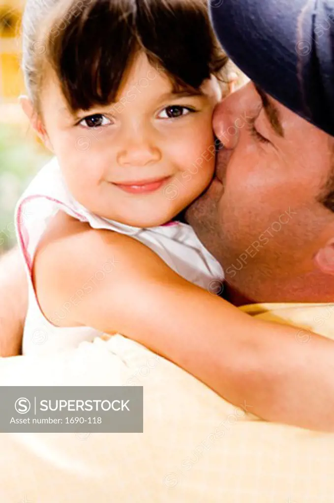 Portrait of a girl hugging her father