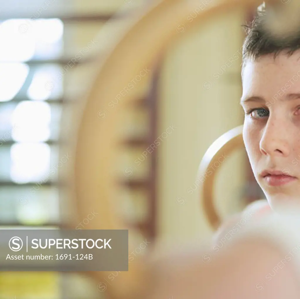 Portrait of a male gymnast holding gymnastic rings