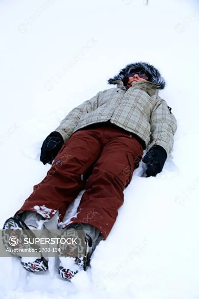 Young woman lying in the snow