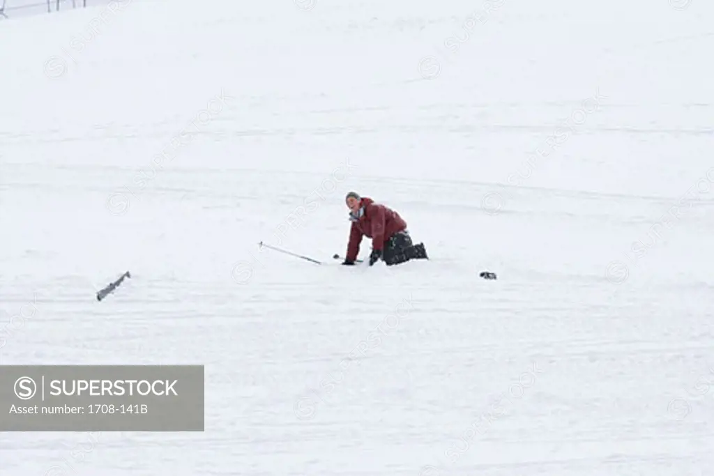 Young man kneeling on snow