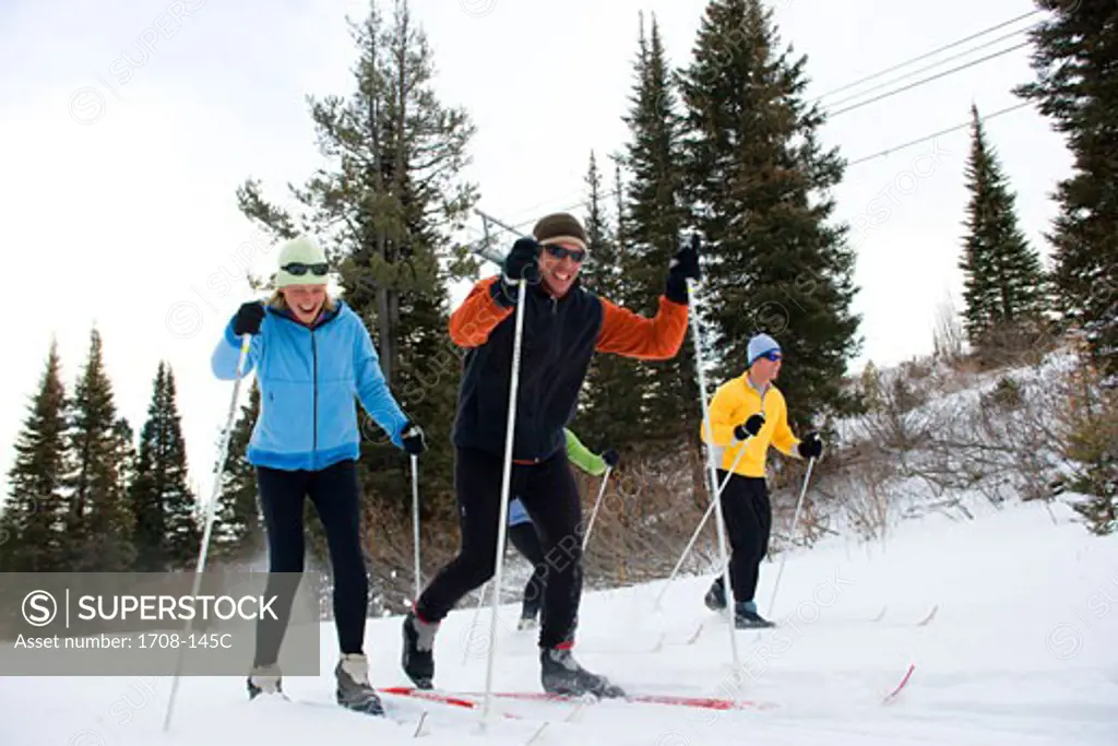 Four people skiing