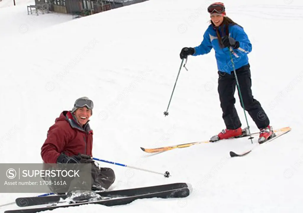 Young adult couple skiing