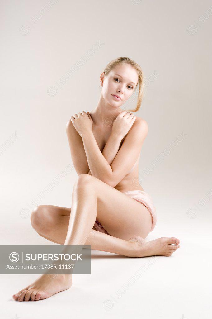 Portrait of a beautiful woman covering her breasts stock photo