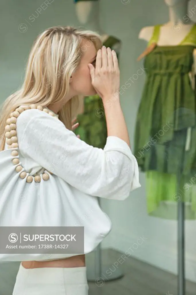 Woman window shopping in a boutique