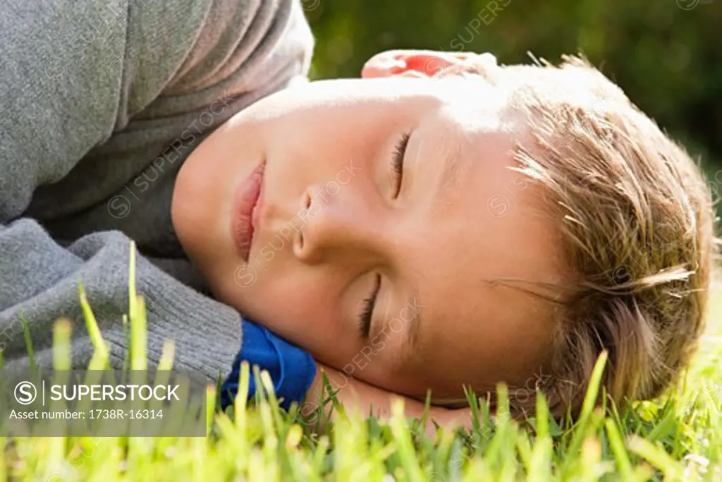 Boy napping on grass