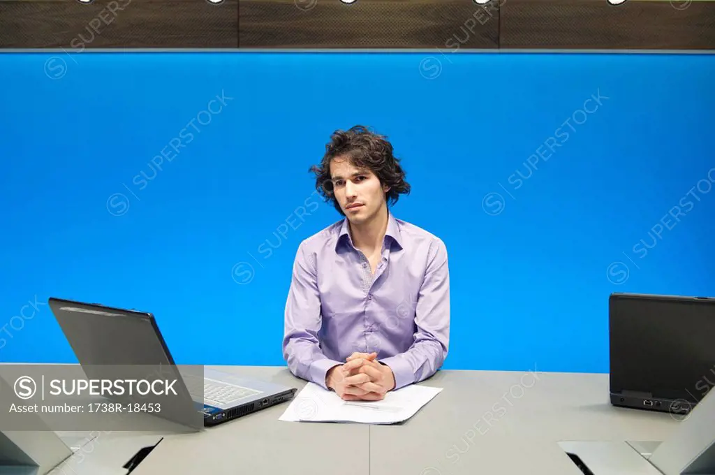 Businessman at a conference table with a laptop