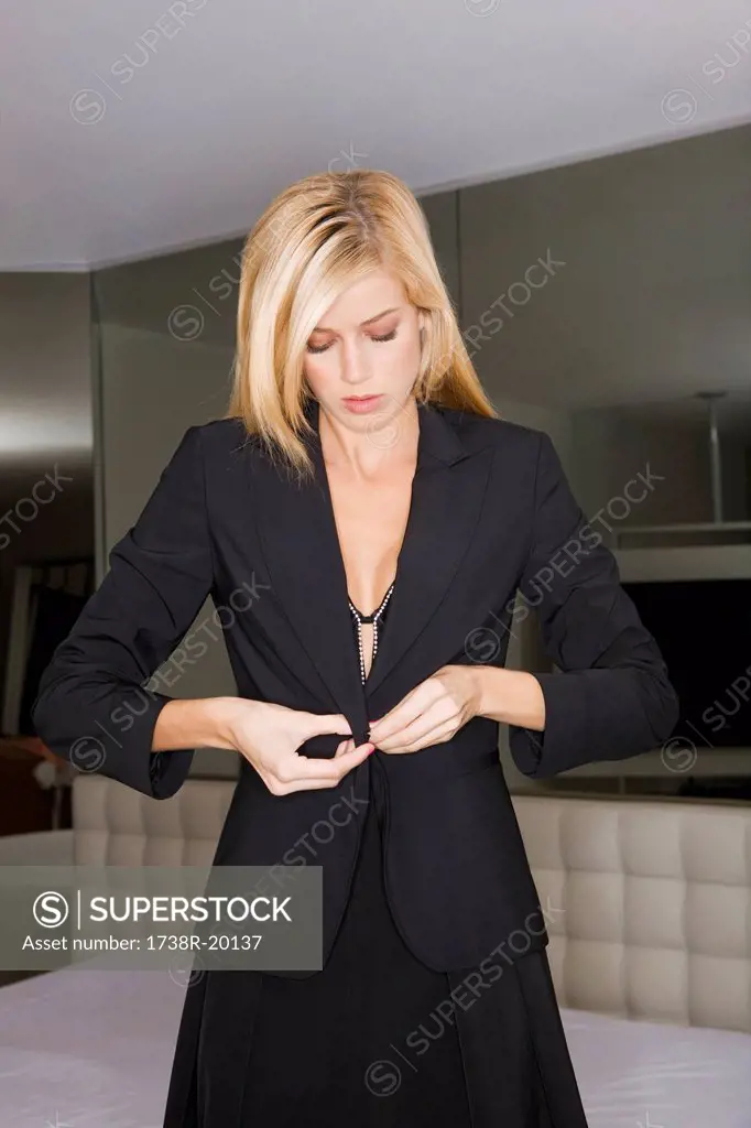 Young woman getting dressed