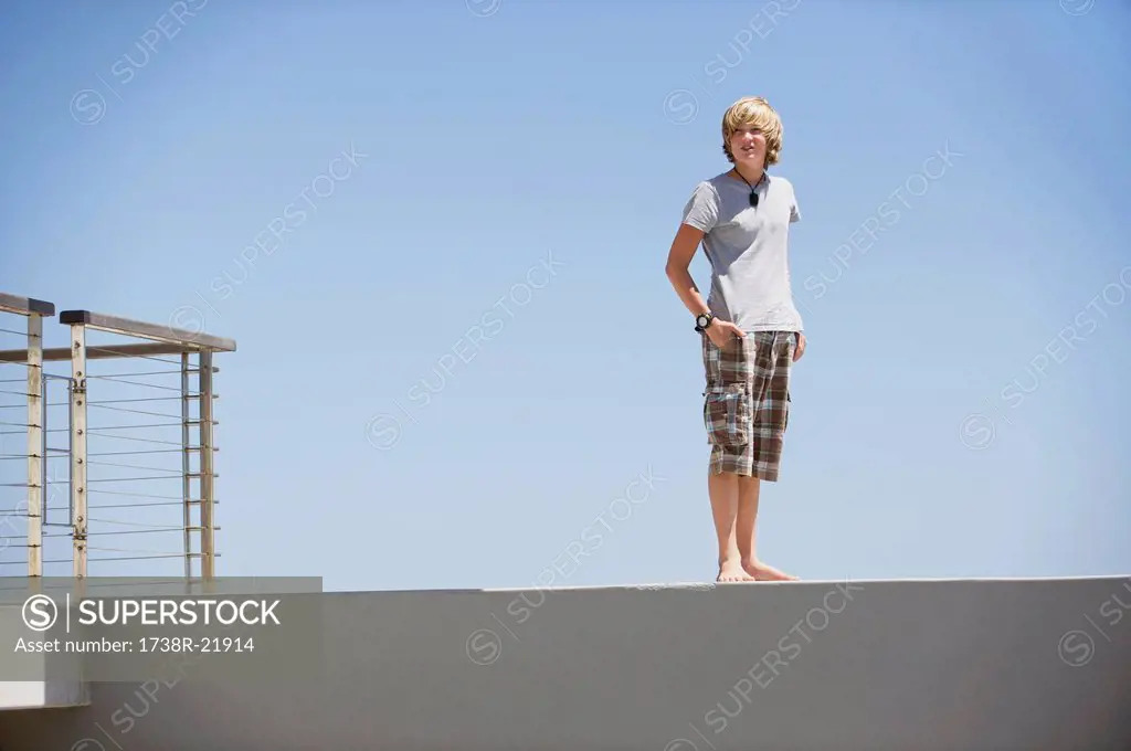 Teenage boy standing at the edge of a terrace