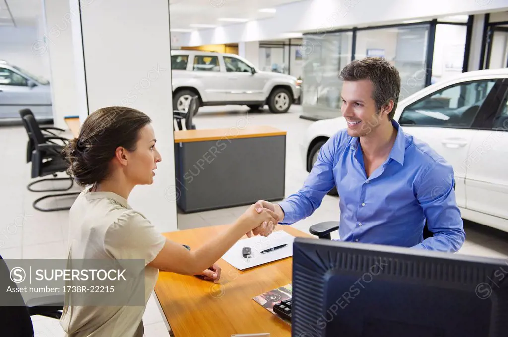 Saleswoman shaking hands with her customer