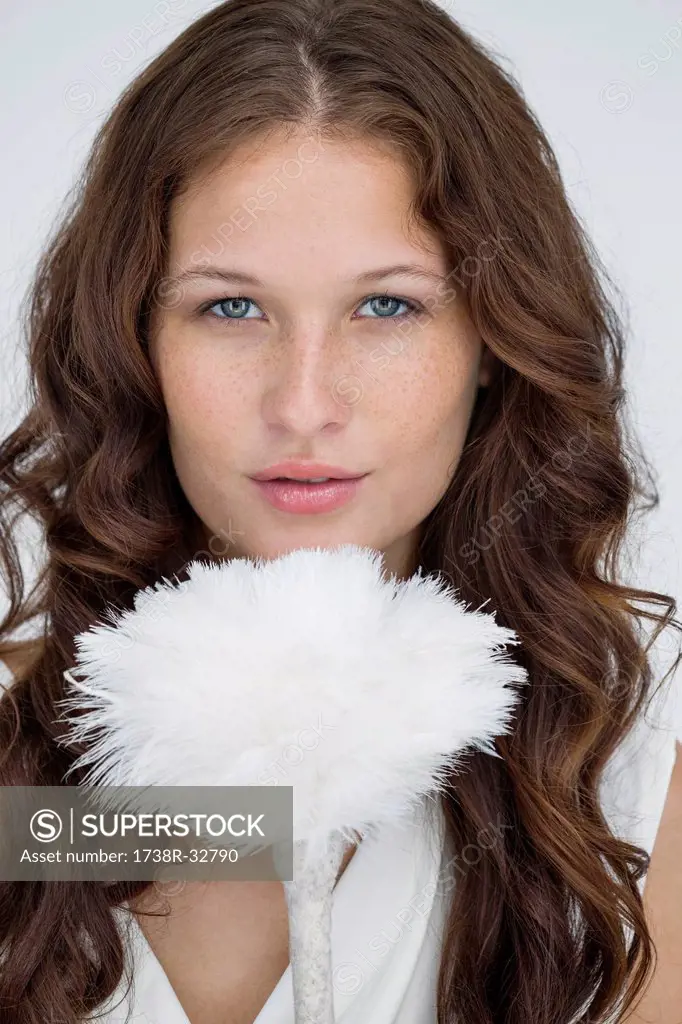 Portrait of a woman holding a feather duster