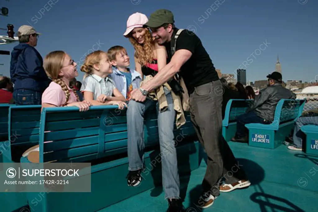 Family of five having fun on a boat