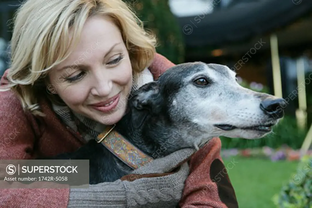 Mature woman hugging a dog