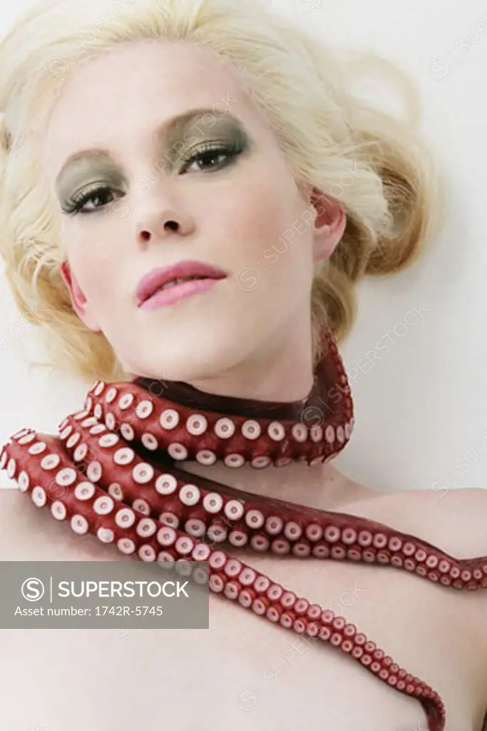 Woman with an octopus wrapped around her neck and shoulder