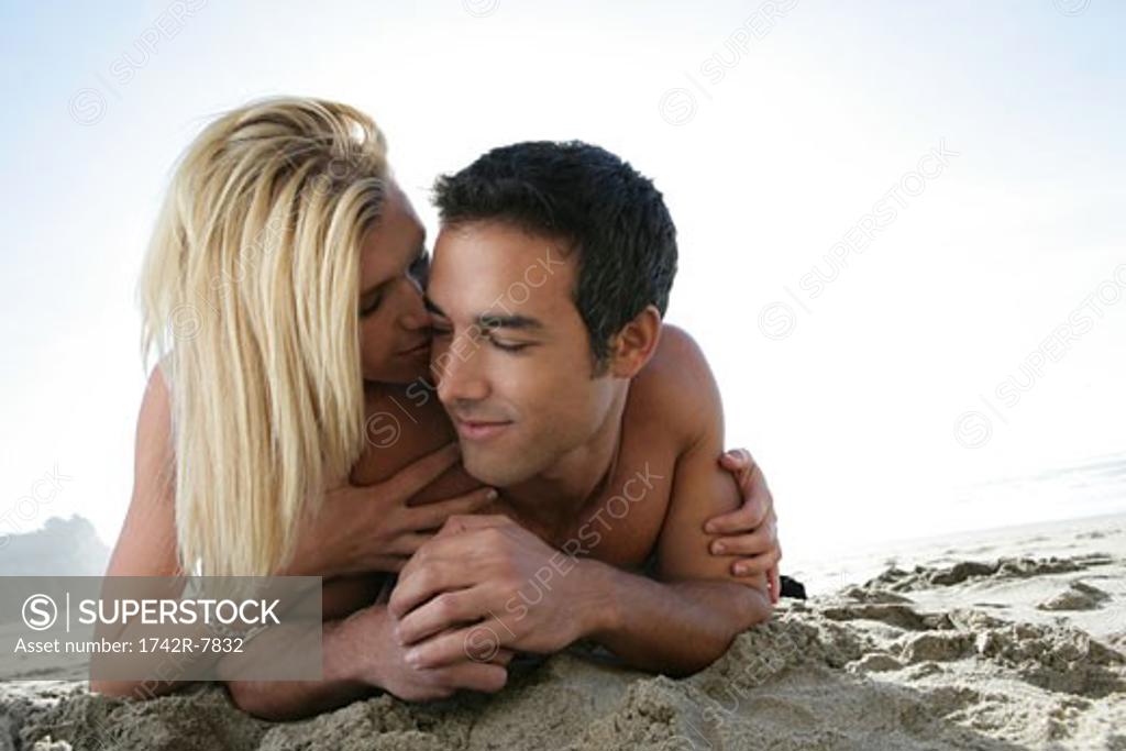 Naked women in panties hugging on beach - Stock Photo [81729898