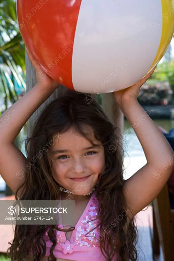 Portrait of a girl holding a beach ball