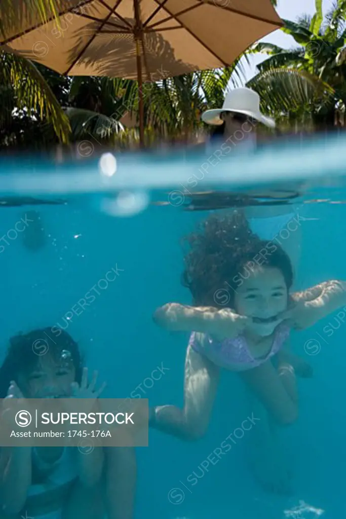 Two girls swimming underwater