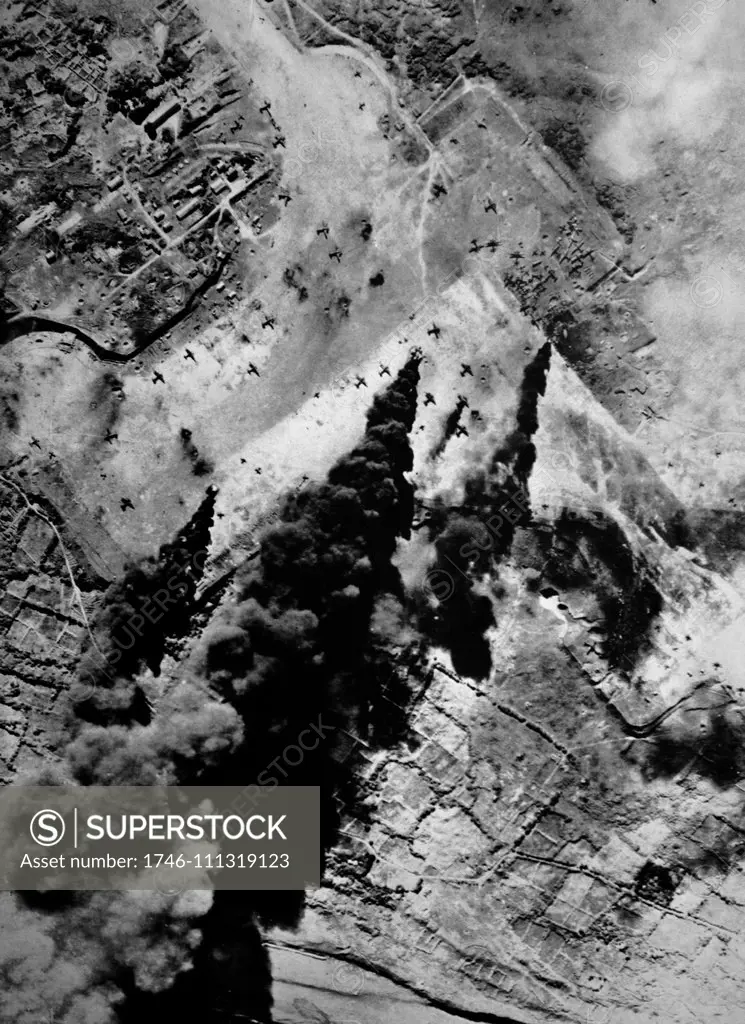 Pre-Invasion Bombing, Iwo-Jima U.S. Army Air Forces. Among the main targets in the Iwo campaign were the airstrips. Here, in softening-up bombing runs, Jap planes are subjected to accurate fire while parked on one of the airstrips on Iwo. The columns of smoke show effectiveness of 7th Air Force bombers. March 1945.