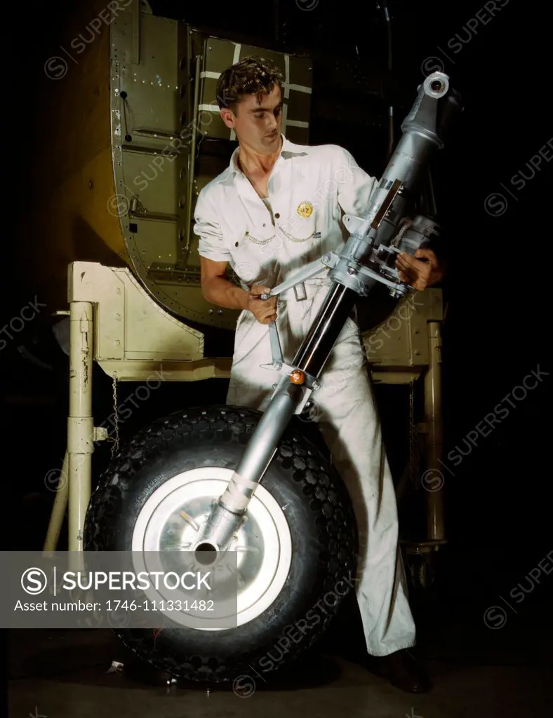 Colour photograph of a nose wheel and landing gear assembly for a B-25 bomber under construction in a western aircraft plant, North American Aviation, Inc., Calif. Dated 1942