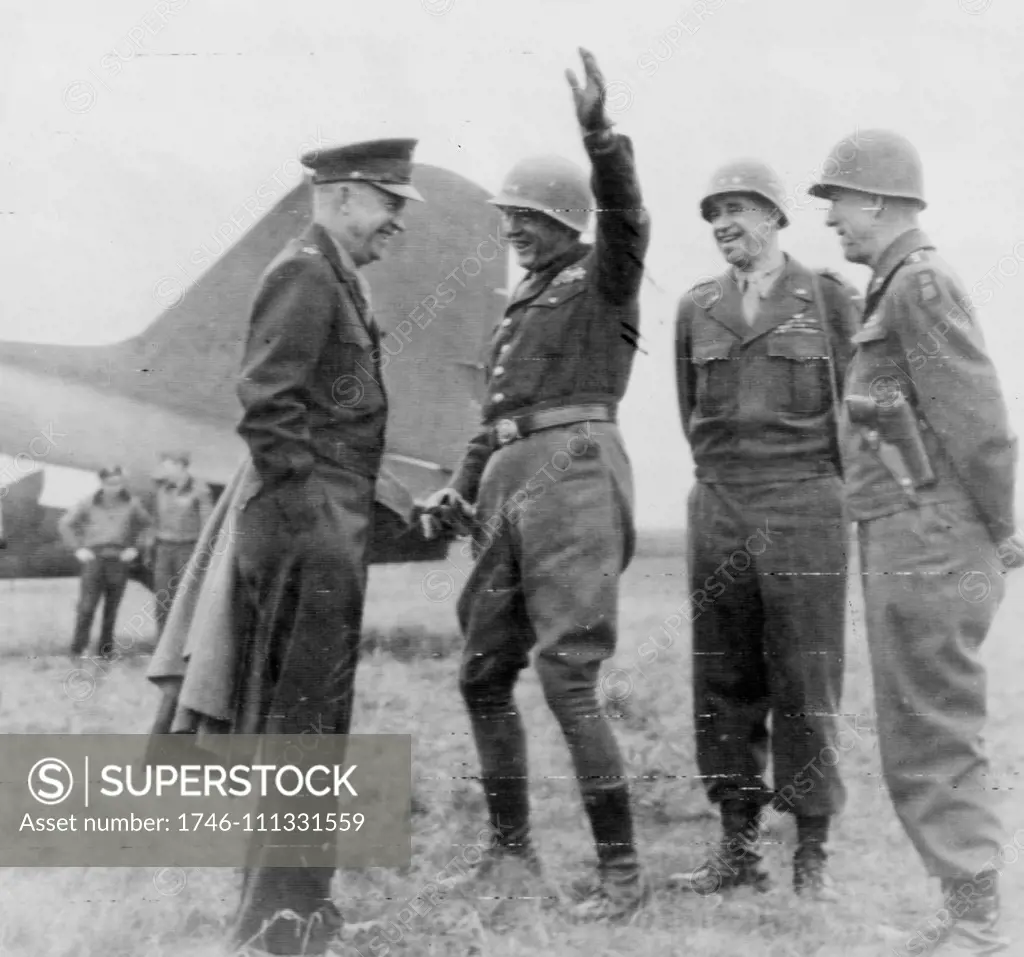 Photograph shows General Eisenhower meeting with generals Patton, Bradley, and Hodges on an airfield somewhere in Germany. Dated 1945