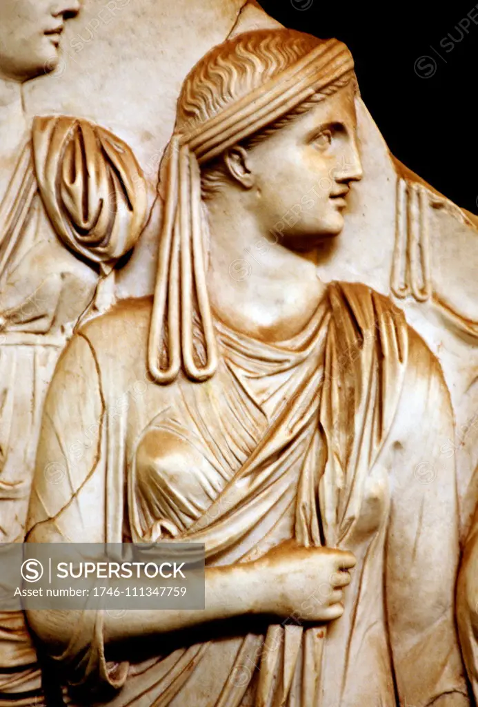 Detail of a relief, depicting the adventus (arrival) of Vespasian in Rome after his victory in the civil wars in 69 CE. ; Vestal Virgin, wearing a distinctive headdress composed of a band of wool wrapped several times around the head (infula) with long looped side pieces (vittae). Rome, Vatican Museum,