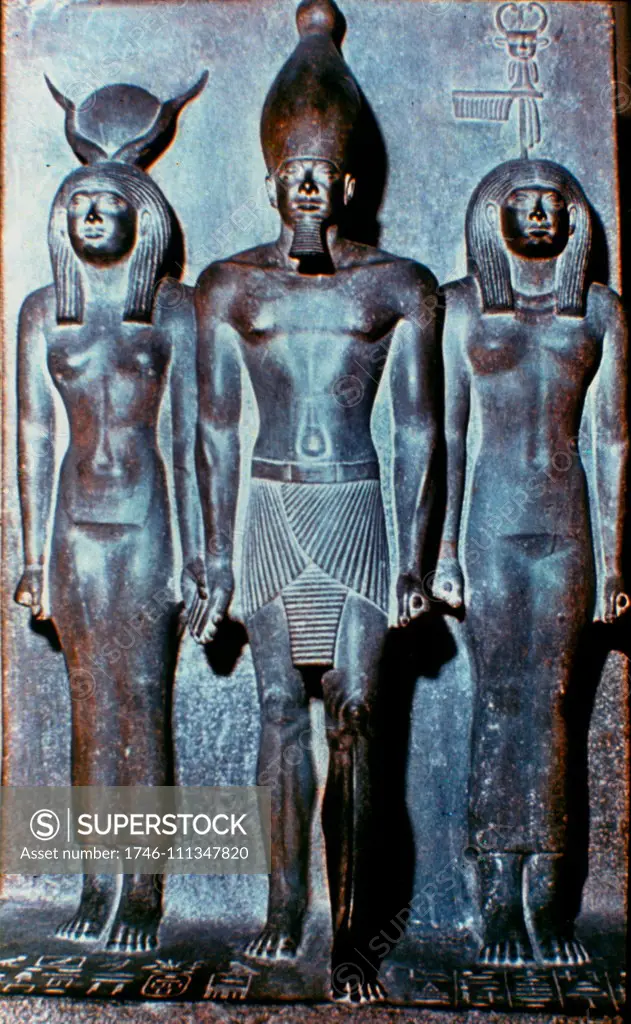 Menkaura flanked by the goddess Hathor (left) and a nome goddess Bat (right). Greywacke statue (Egyptian Museum, Cairo). Menkaure was an ancient Egyptian king (pharaoh) of the 4th dynasty during the Old Kingdom. circa 2500 BC