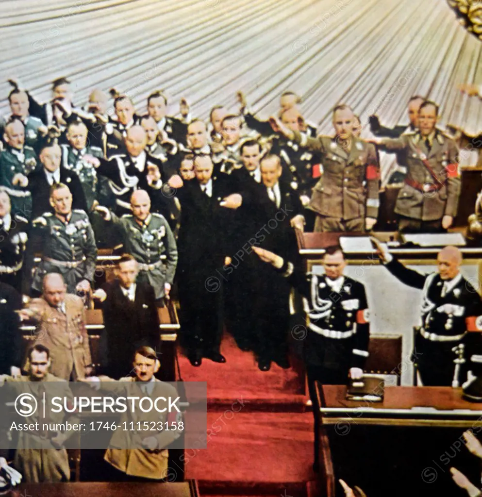 Adolf Hitelr with Nazi deputies in the reichstag in 1939 following a speech by the Fuhrer at a mass rally in Germany 1939