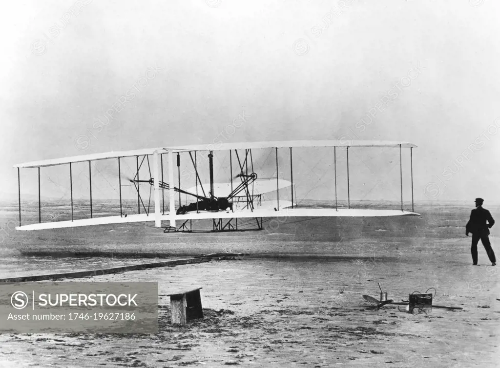 The first powered flight, December 17 1903, Kitty Hawk, North Carolina. Wilbur and Orville Wright. Photograph Acknowledgement must be made to The Smithsonian Institution