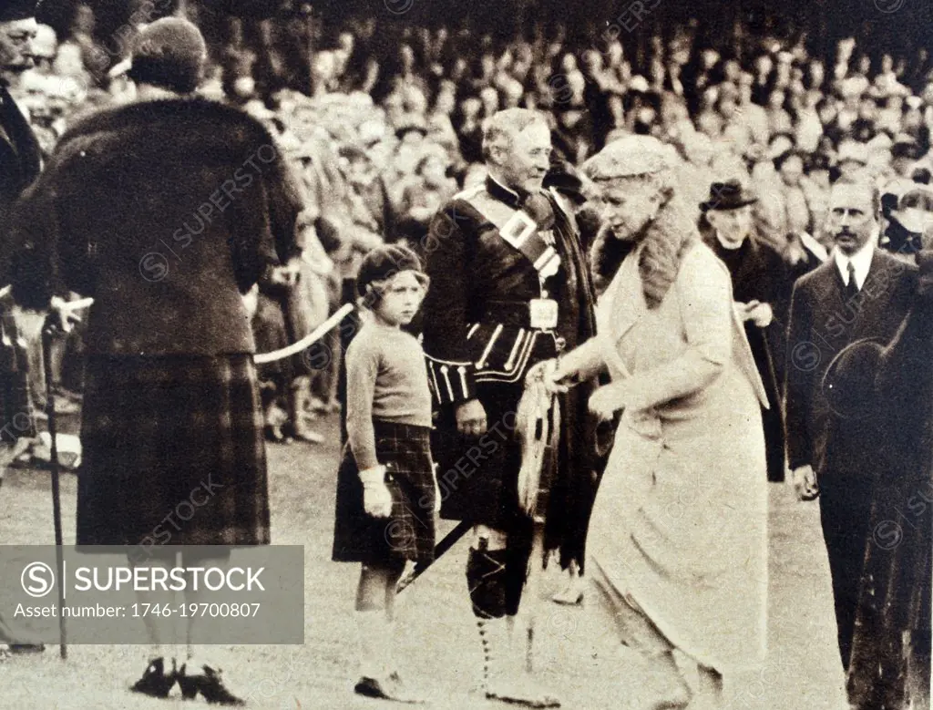 Photograph of arrival of King George V and Queen Mary of Teck arriving for the Highland Games. Princess Elizabeth is in the foreground. Dated 1935