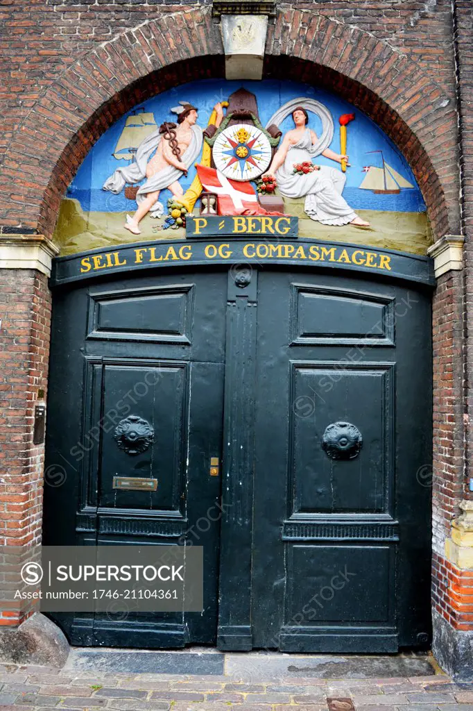 Old sign for a flag and compass maker 'Seil Flag og Compasmager' in Copenhagen's Nyhaven area, Denmark