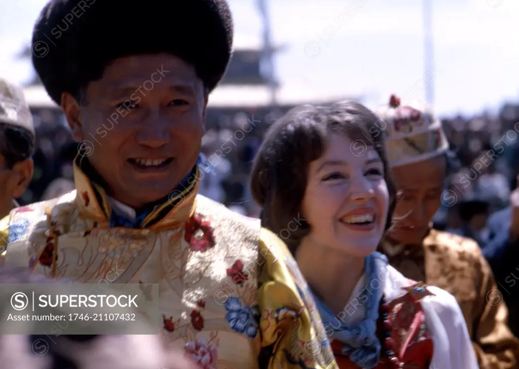 Colour photograph of King Palden Thondup Namgyal (Chogyal of Sikkim) (1923-1982) and Queen Hope Cooke (1940-) walking in procession, Gangtok, Sikkim, Dated 1965