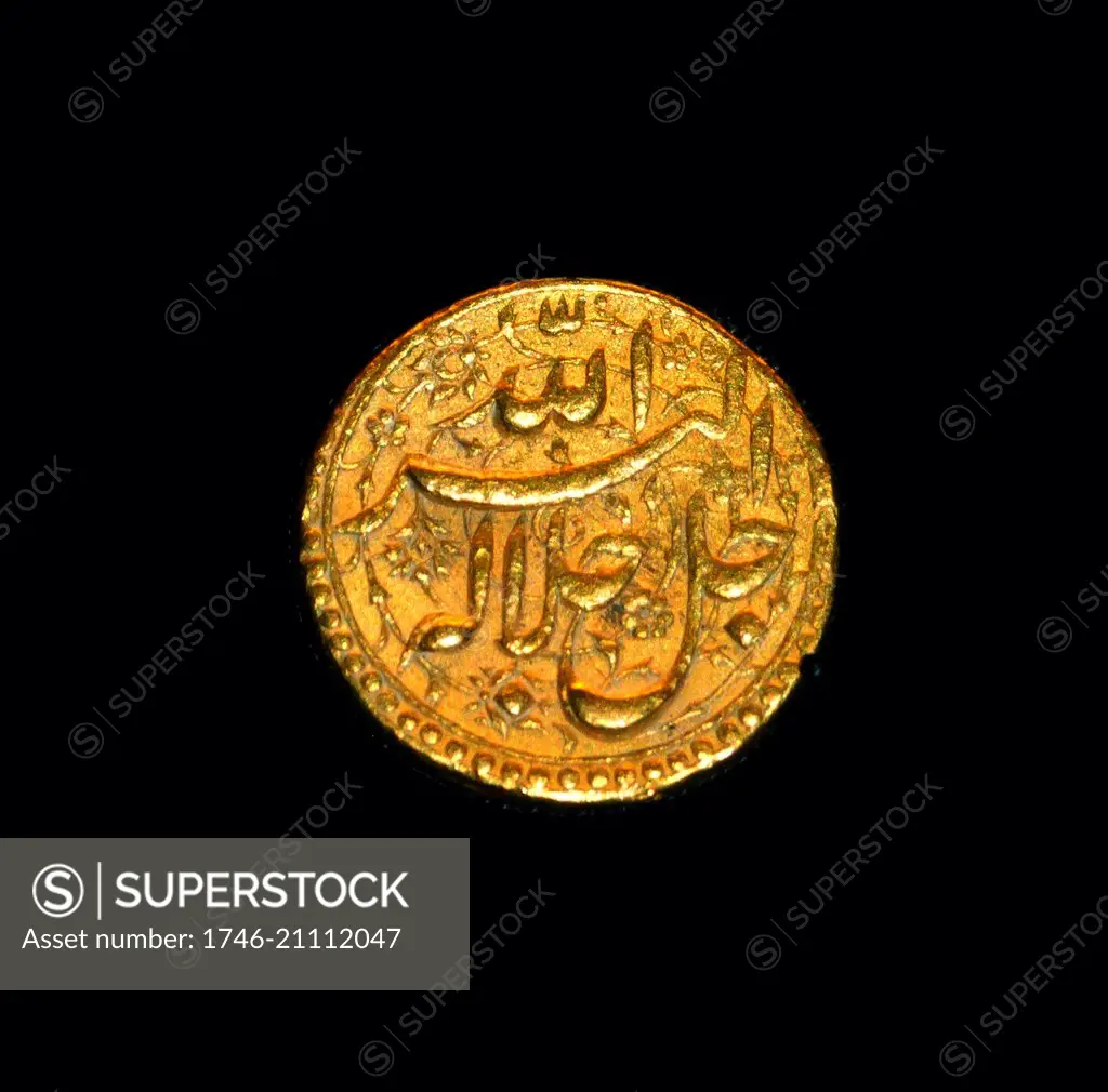 Gold Mughal coin of Emperor Akbar, Agra 1556-1605 This gold coin carries ornate Persian inscriptions which include the names of Persian months.