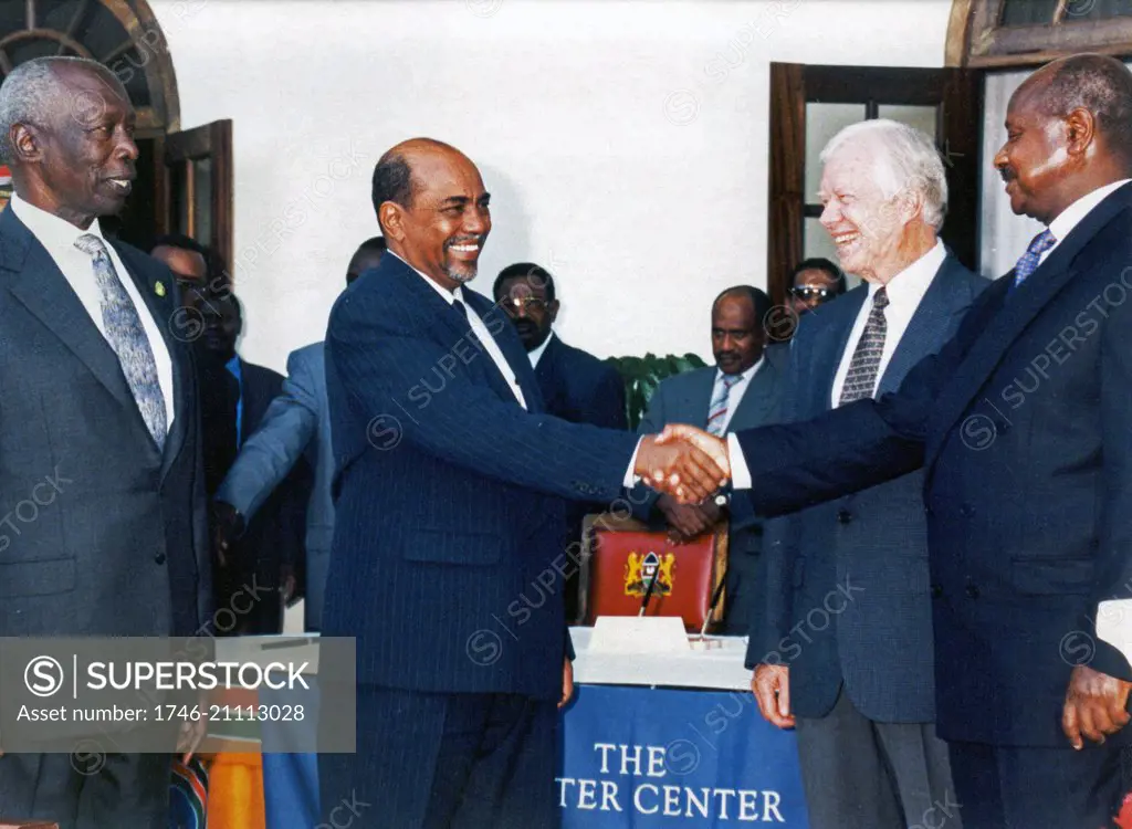 Photograph of President Jimmy Carter (1924-) mediating a peace accord between Sudan and Uganda. Dated 1999