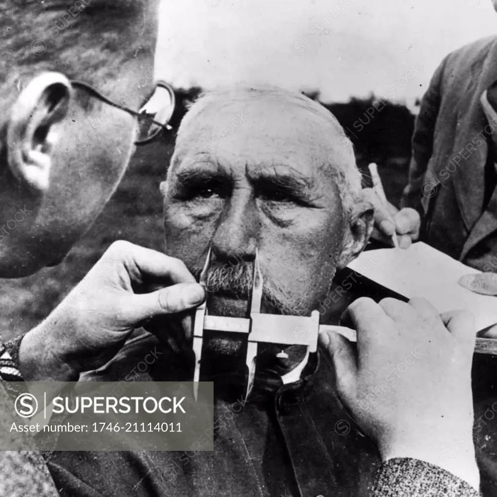 A man having his nose measured during Aryan race determination tests under Nazi Germany's Nuremberg Laws that was applied to determine whether a person was considered a 'Jew'